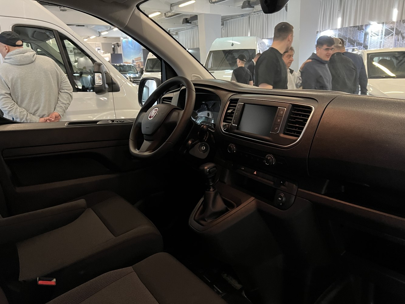 Van interior with dashboard, steering wheel, and manual gear lever