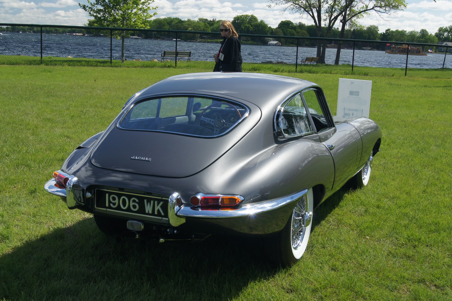 Rear view of a sleek classic sports car with wire wheels and chrome bumper