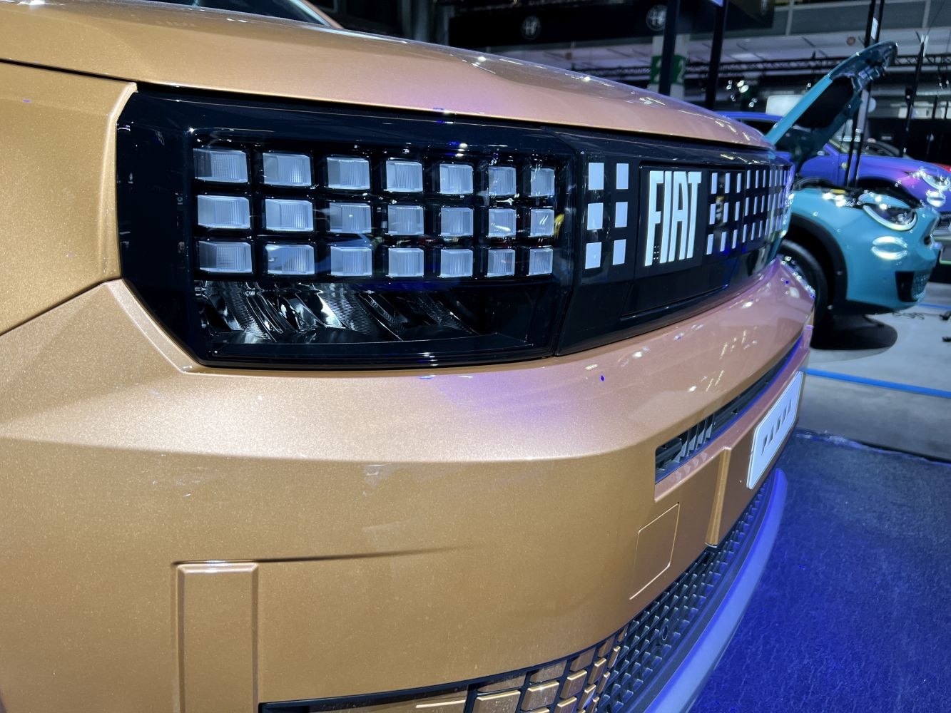Pixel-style headlights and bold front grill of a compact vehicle