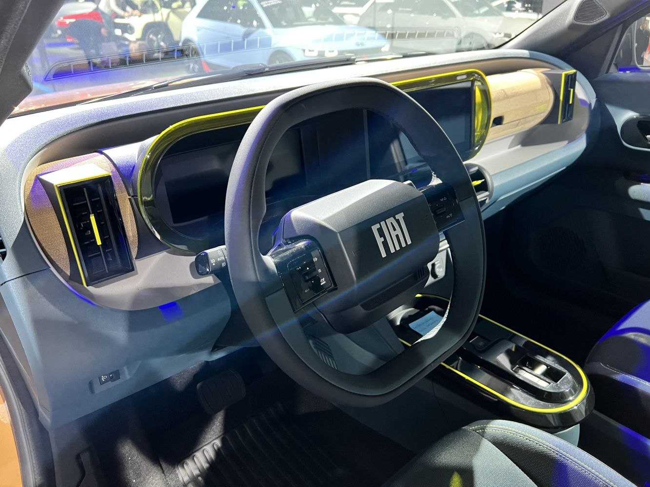 Digital dashboard and unique shaped steering wheel with yellow accent trim