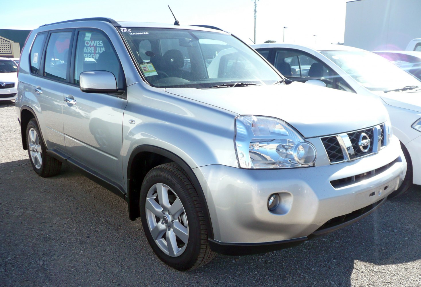 Silver SUV showing front side with distinctive headlights and grille