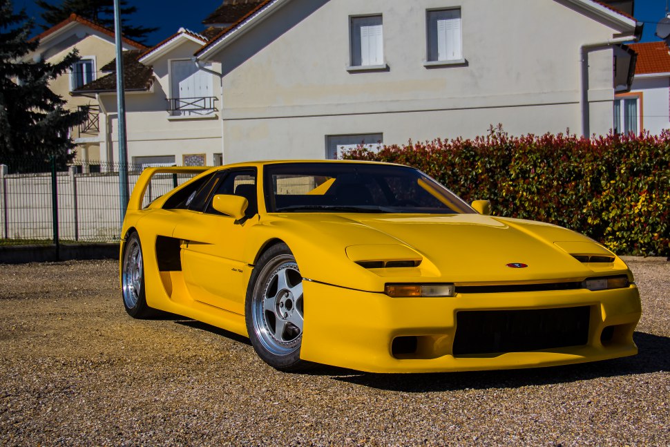 Yellow sports car with sleek aerodynamic body and rear wing