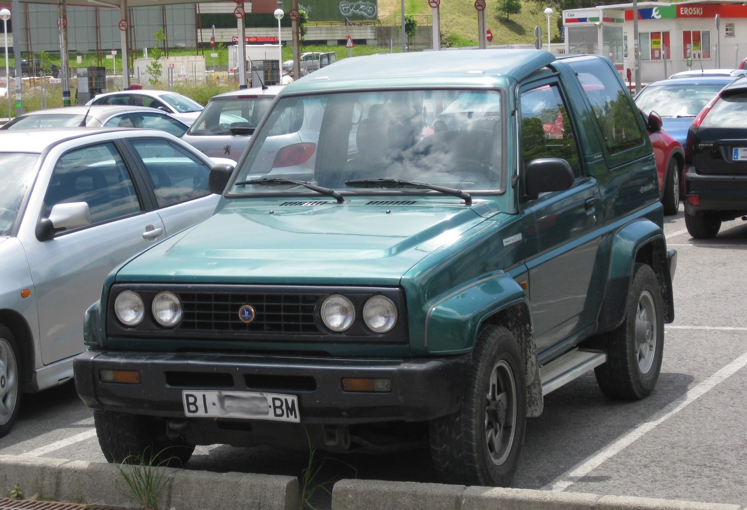 Rugged SUV front end with dual round headlights and off-road wheels