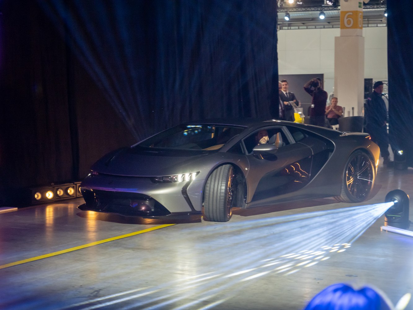 Sleek futuristic sports car with dynamic lighting in showroom
