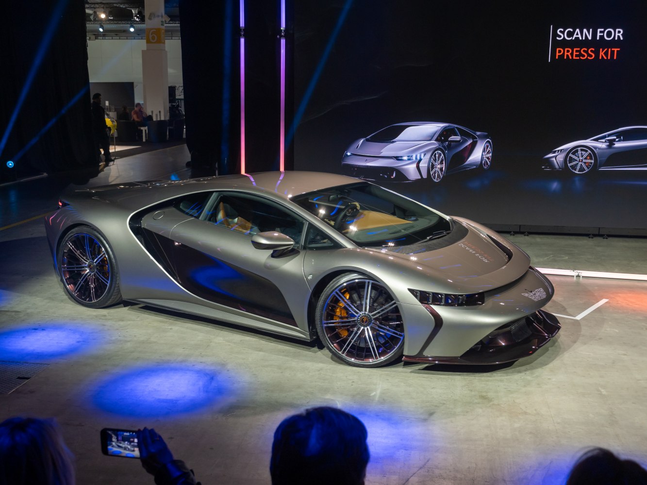Silver sports coupe with aerodynamic body and large multi-spoke alloy wheels