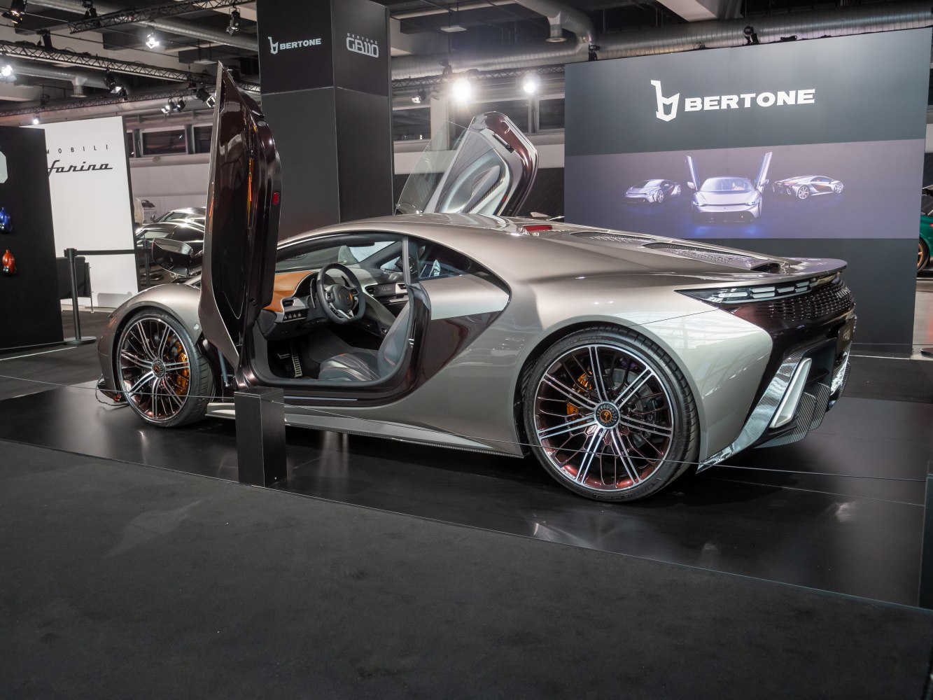 Butterfly doors and multi-spoke alloy wheels on a sports coupe