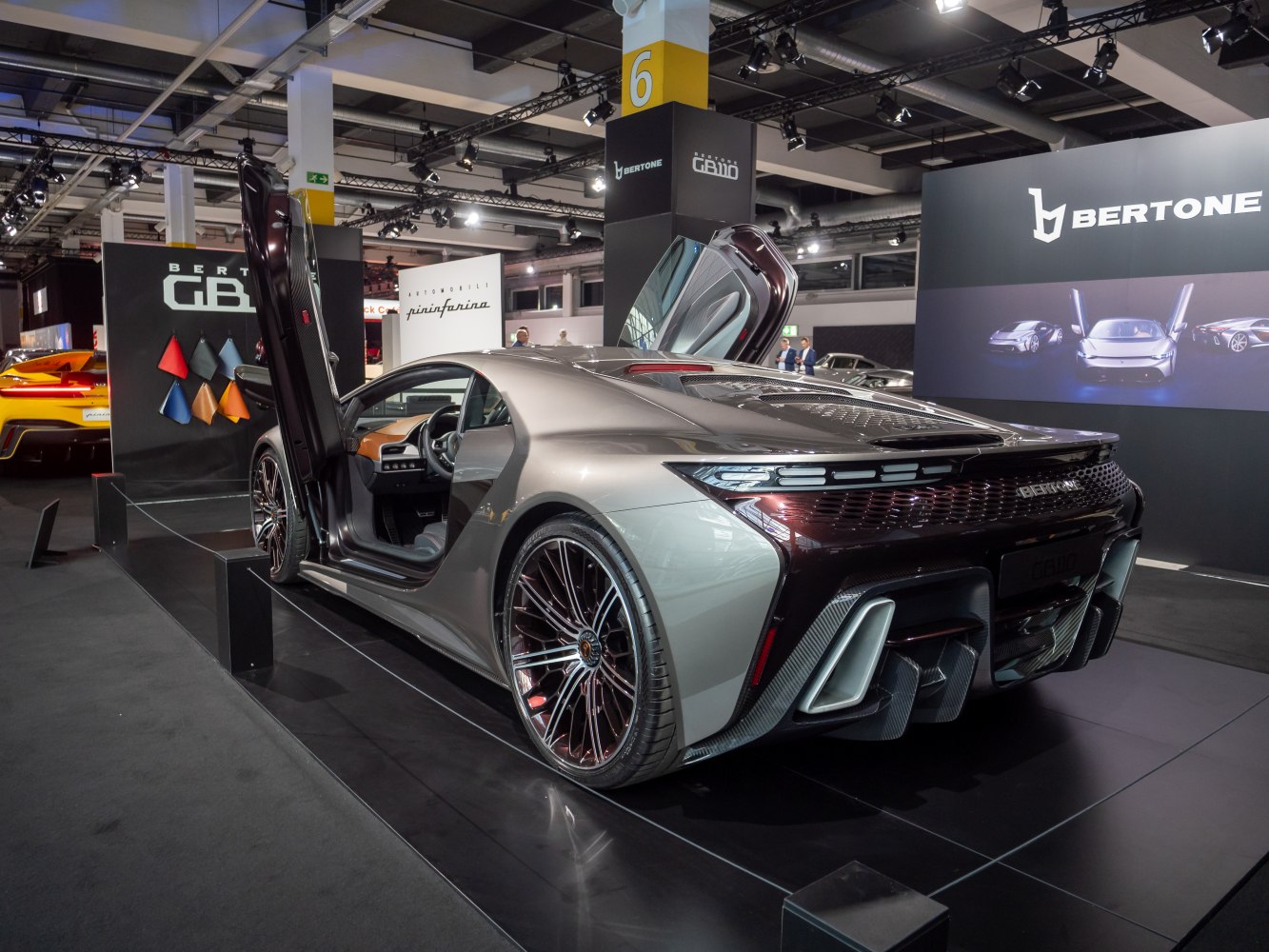 Sports coupe with scissor doors and aerodynamic rear design