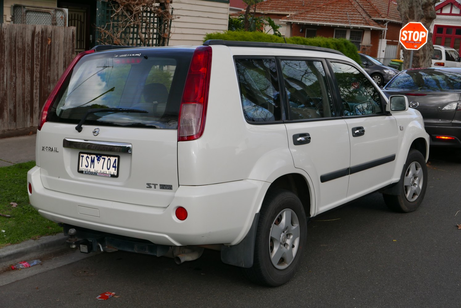 Rear and side view of a white SUV highlighting its tail lights and body profile.