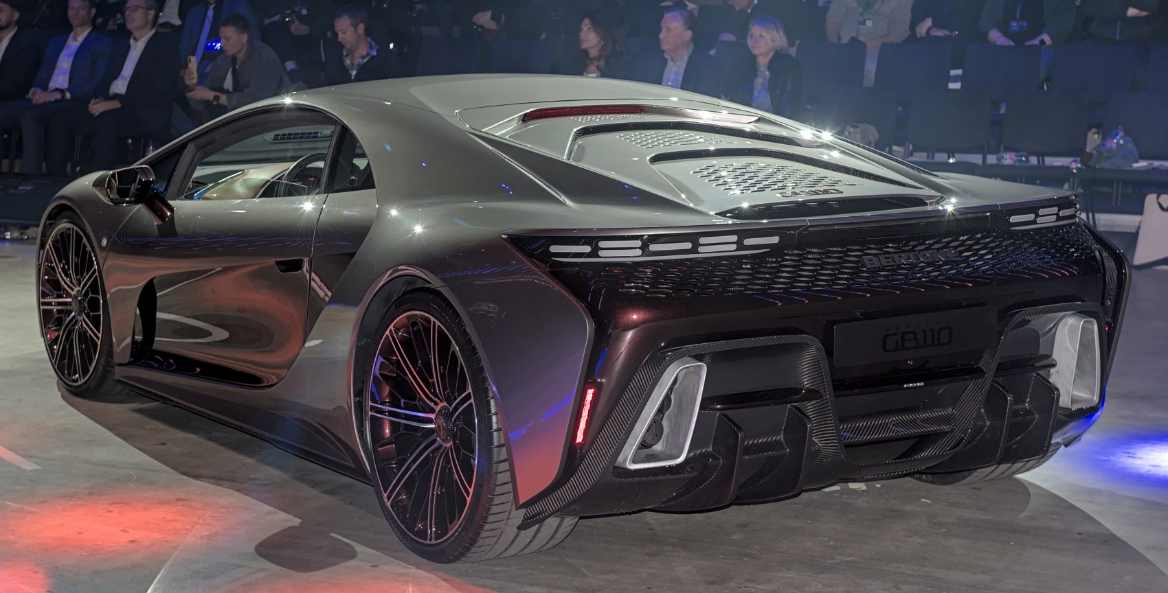Rear view of a sleek sports coupe with aerodynamic design and detailed rear lighting
