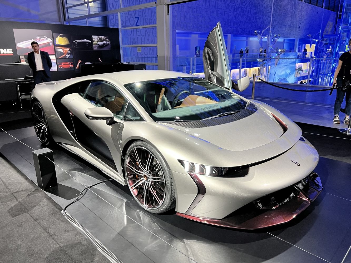 Futuristic sports coupe with scissor doors and advanced aerodynamic front design