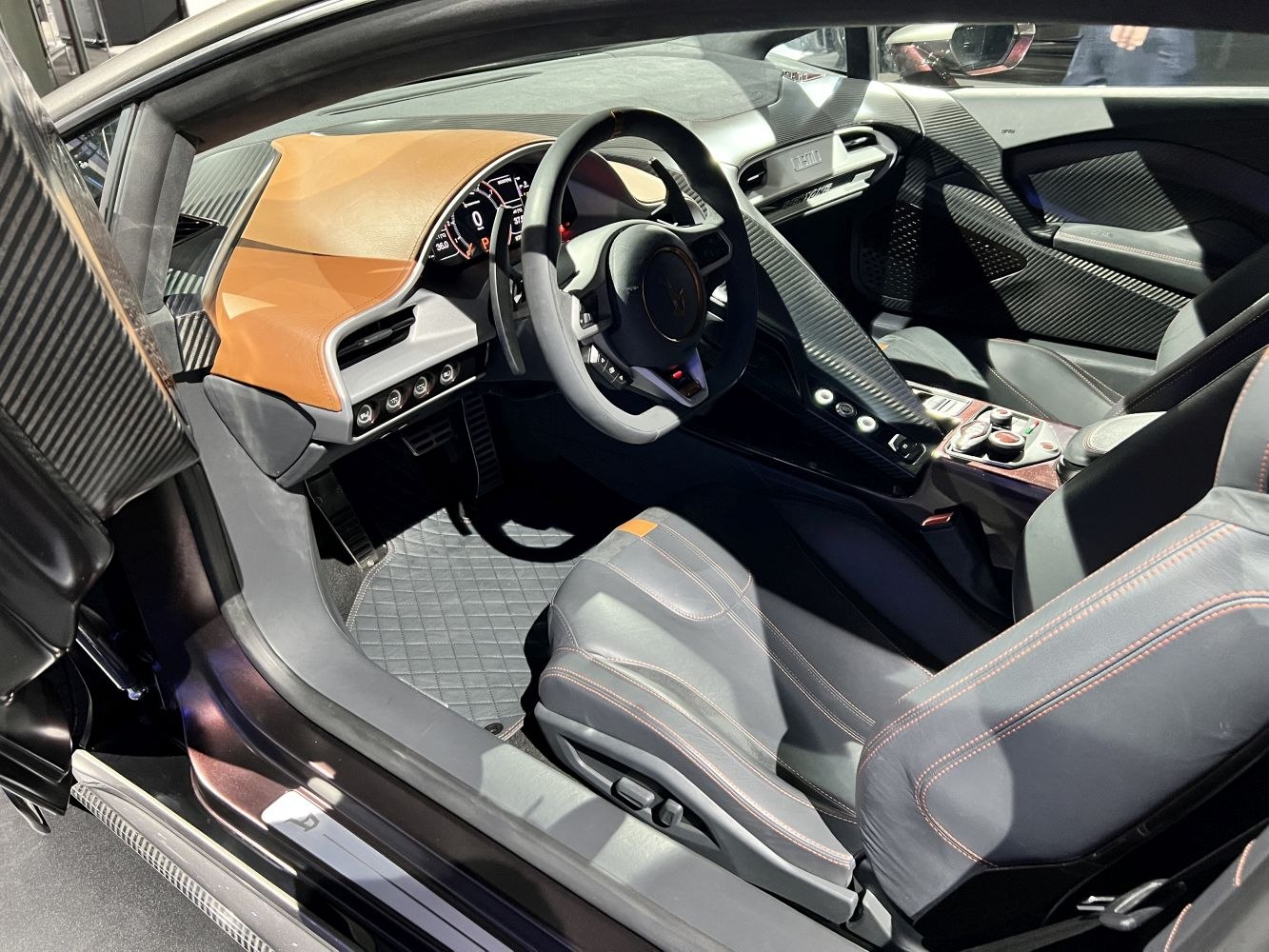 Luxury car interior with carbon fiber trim and leather seats