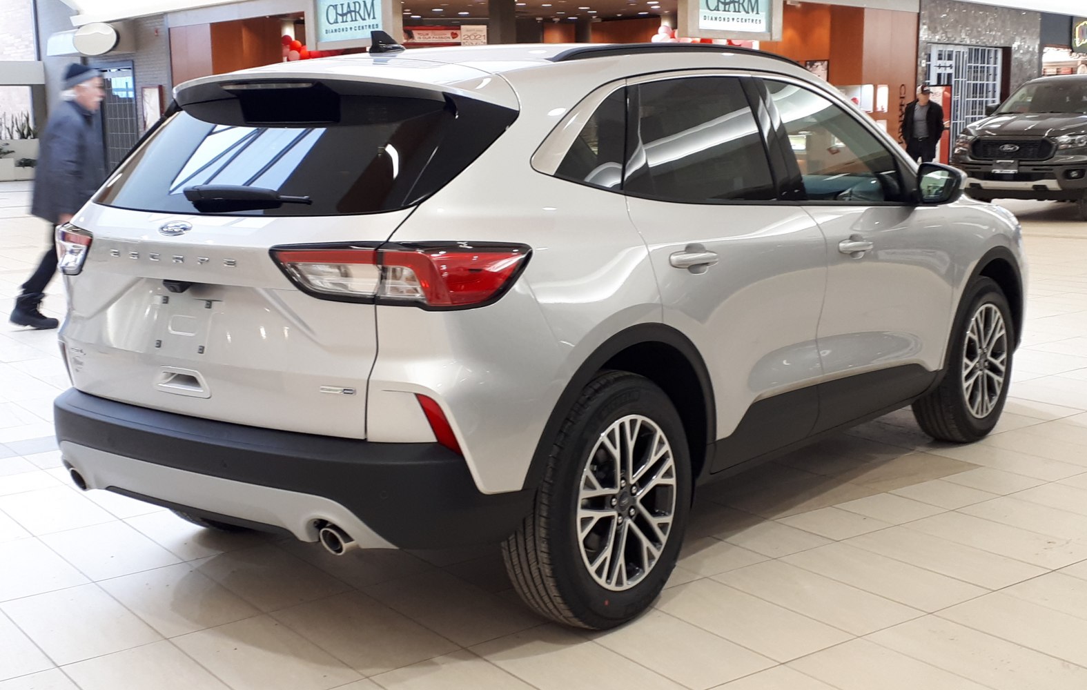 SUV rear angle featuring dual exhaust tips and alloy wheels