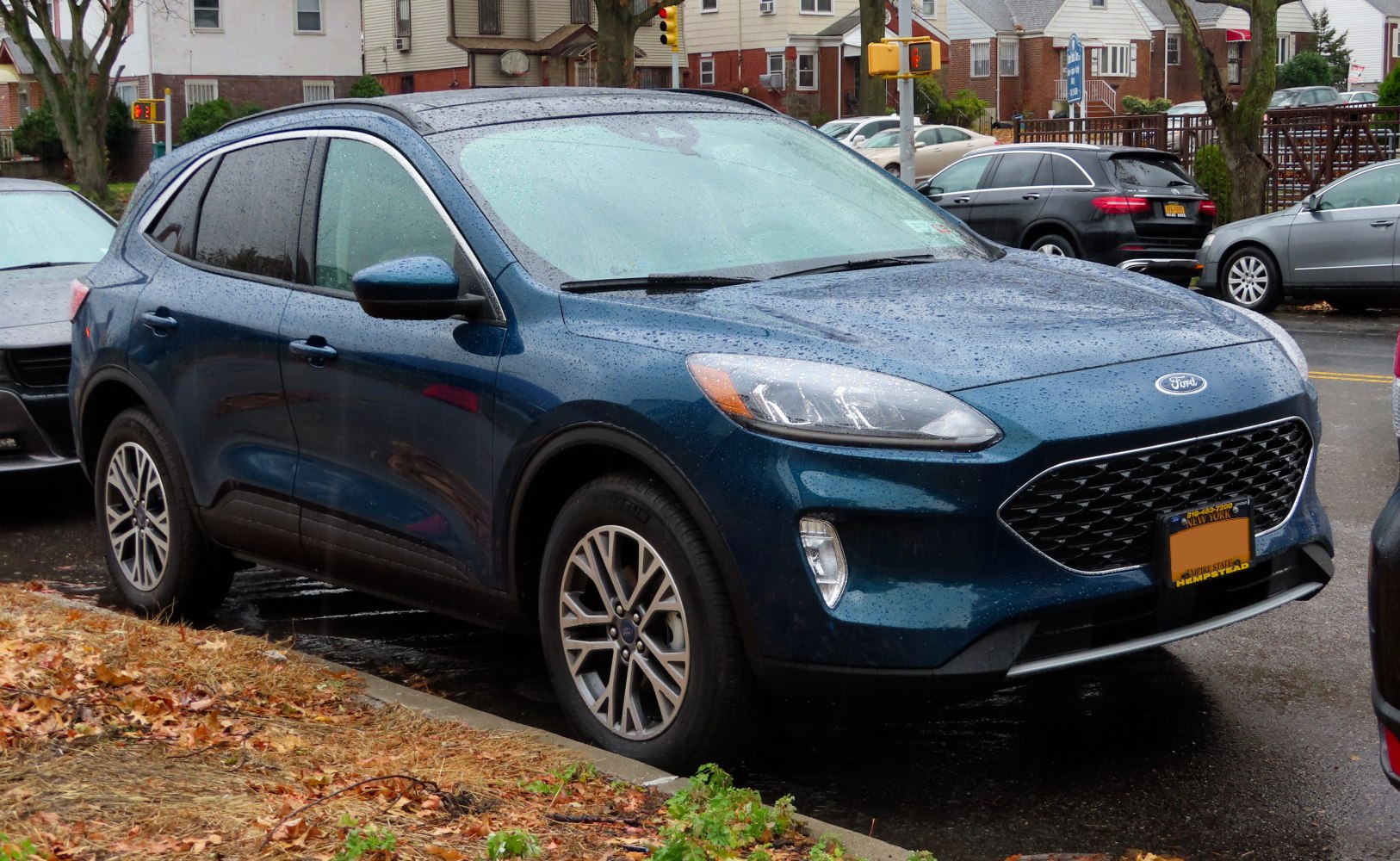 Blue compact SUV with alloy wheels and rain droplets