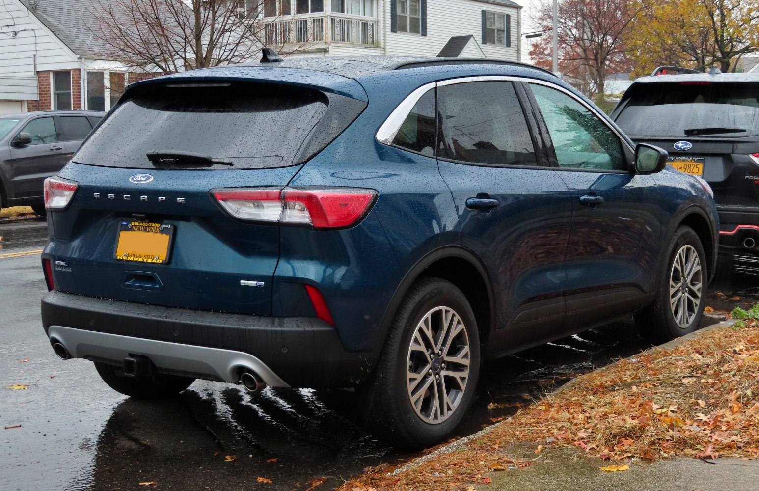 Rear and side view of SUV with dual exhaust and distinct taillights
