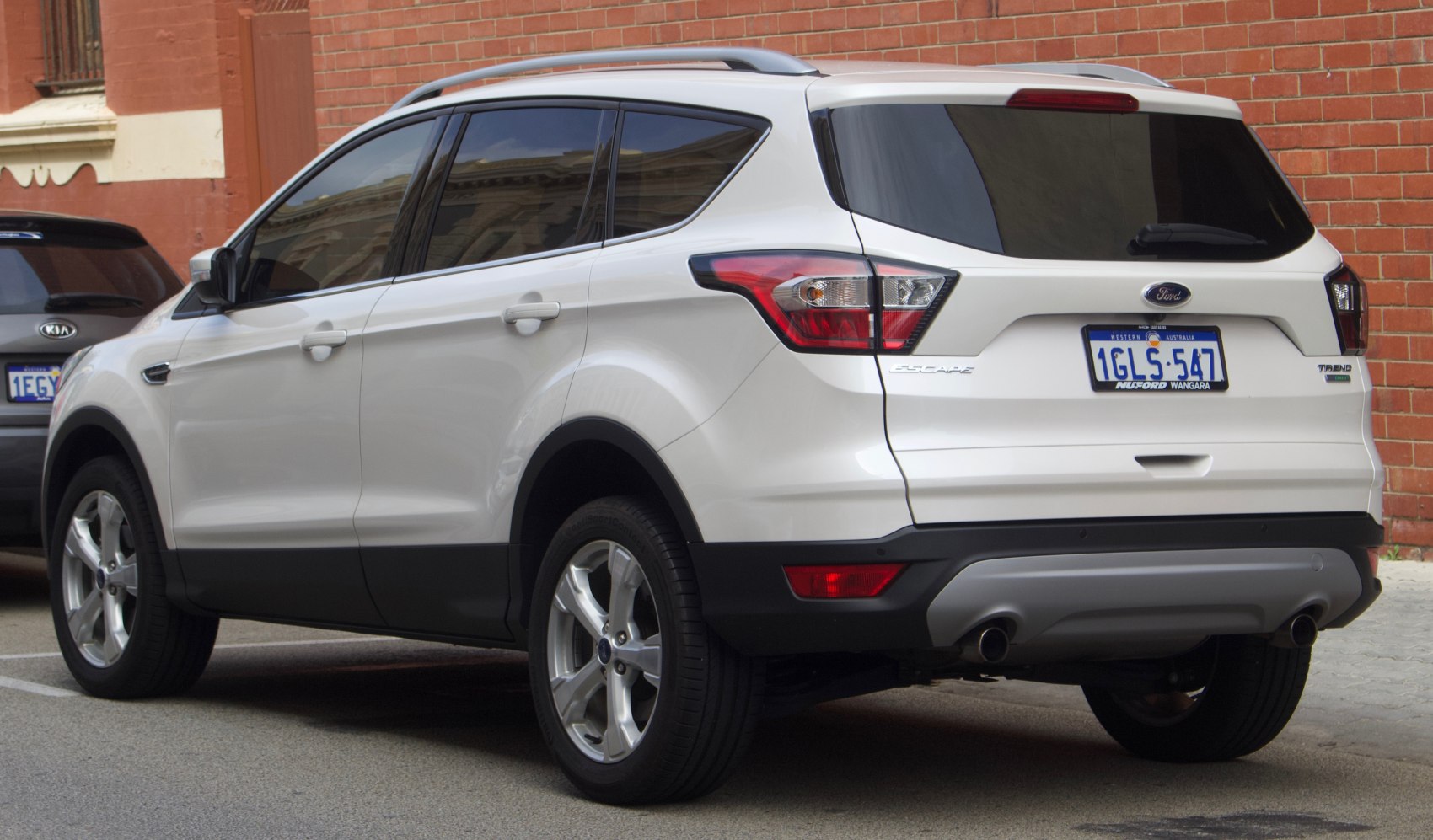 Rear side profile with tinted windows, alloy wheels, and rear lights