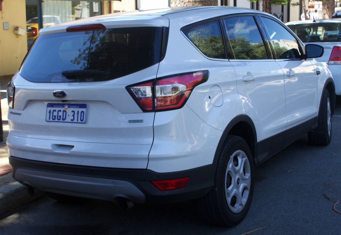 Rear view of white compact SUV with distinct tail lights and rear bumper
