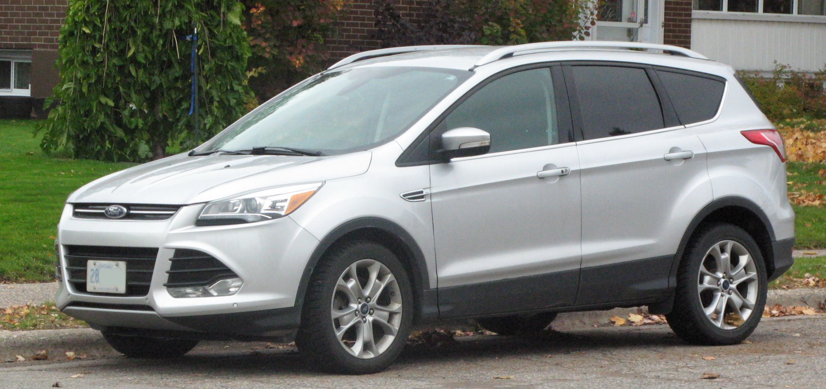 Silver mid-size SUV with modern grille and alloy wheels in side front profile