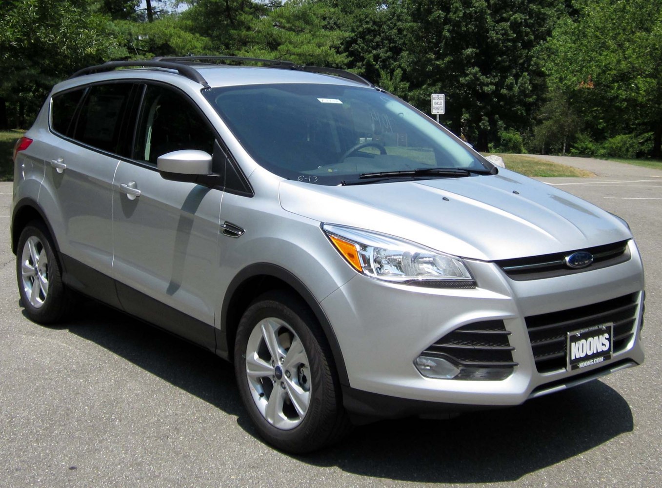 Silver SUV with roof rails and alloy wheels, front side view