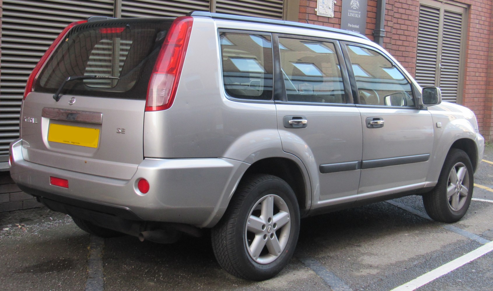 Rear side view of SUV with vertical tail lights and alloy wheels