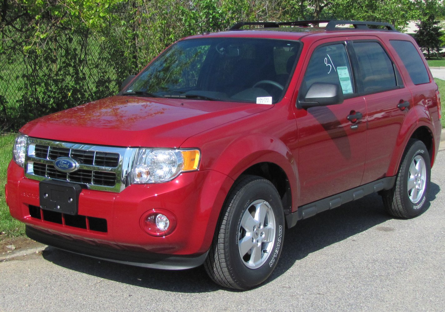 Red SUV with chrome grille and roof rails