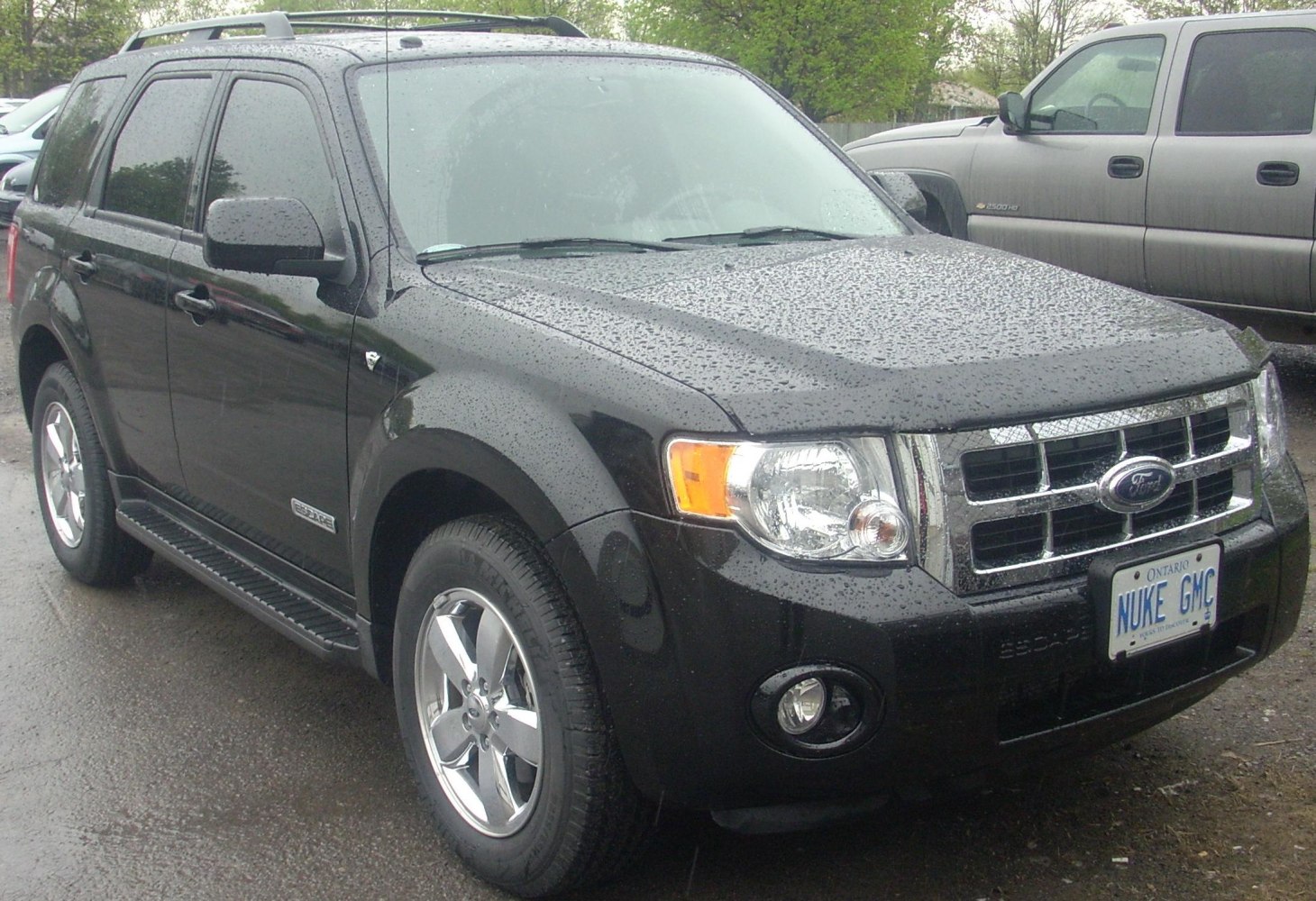 Front-side view of a mid-size SUV with chrome grille and fog lights.
