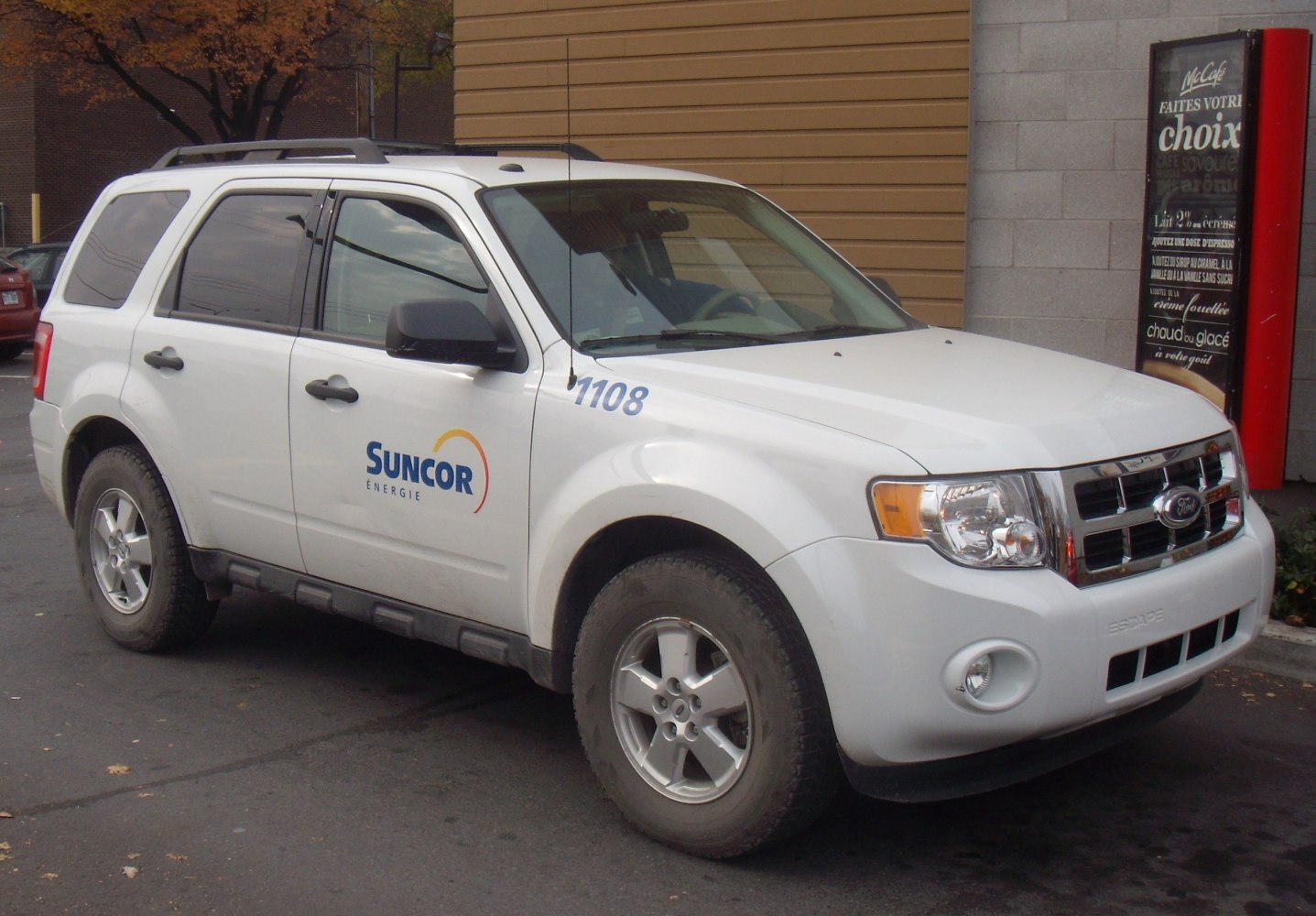 White mid-size SUV side profile with company logo and rugged wheels