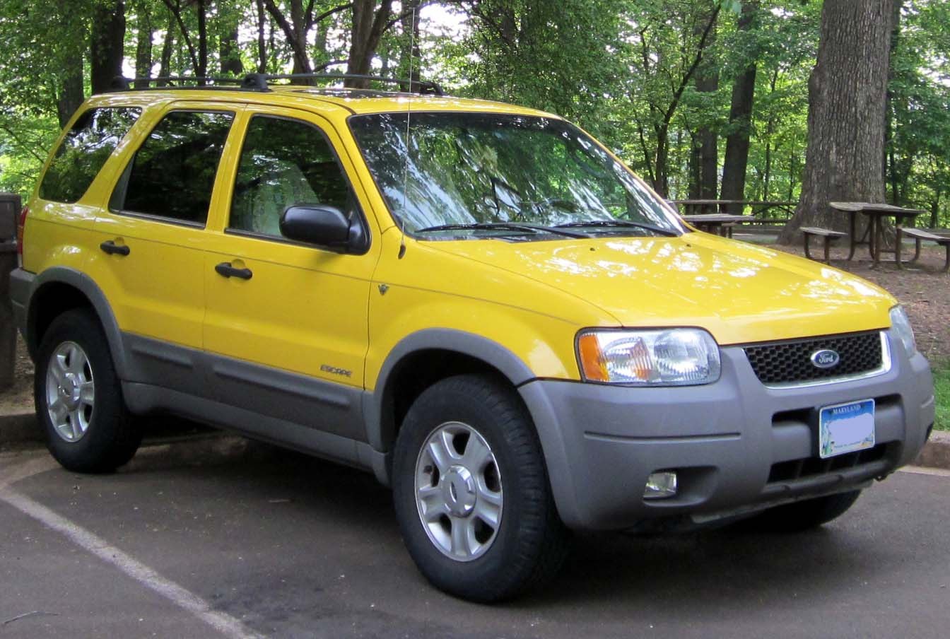 Yellow SUV with roof rack and rugged plastic side trim