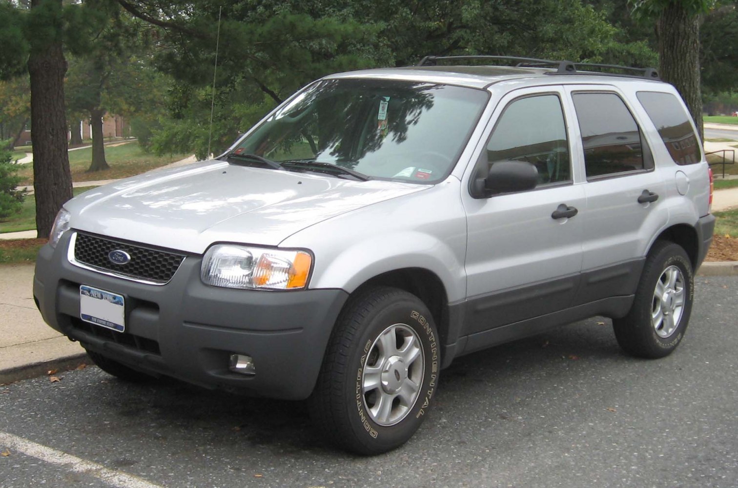 Front side view of SUV with distinctive headlights and black plastic bumper