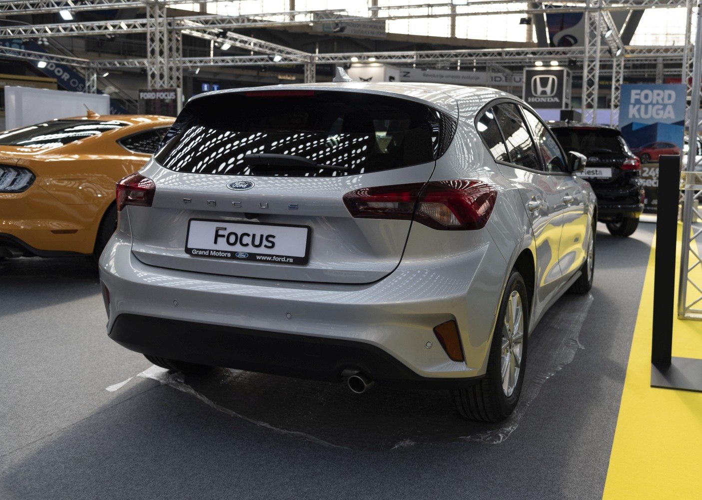 Rear view of a silver compact hatchback with modern taillights.