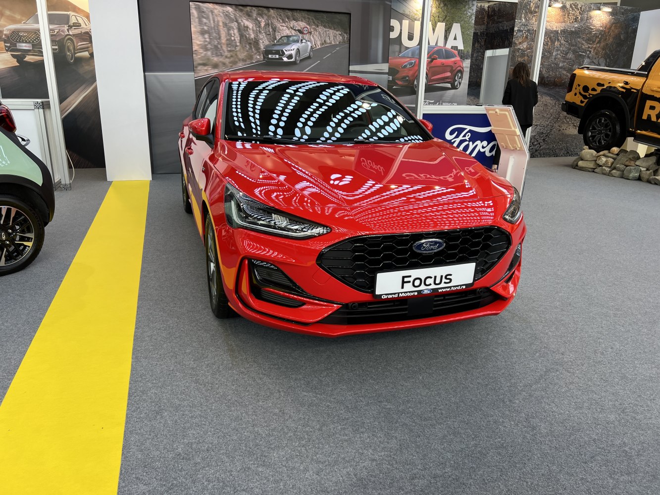 Sporty hatchback front with LED headlights and hexagonal grille.
