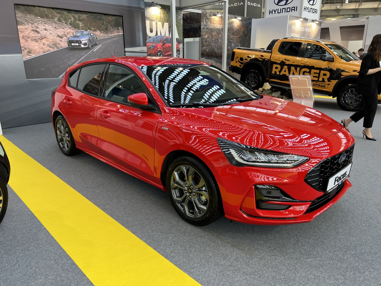 Red hatchback with sleek headlights and modern design