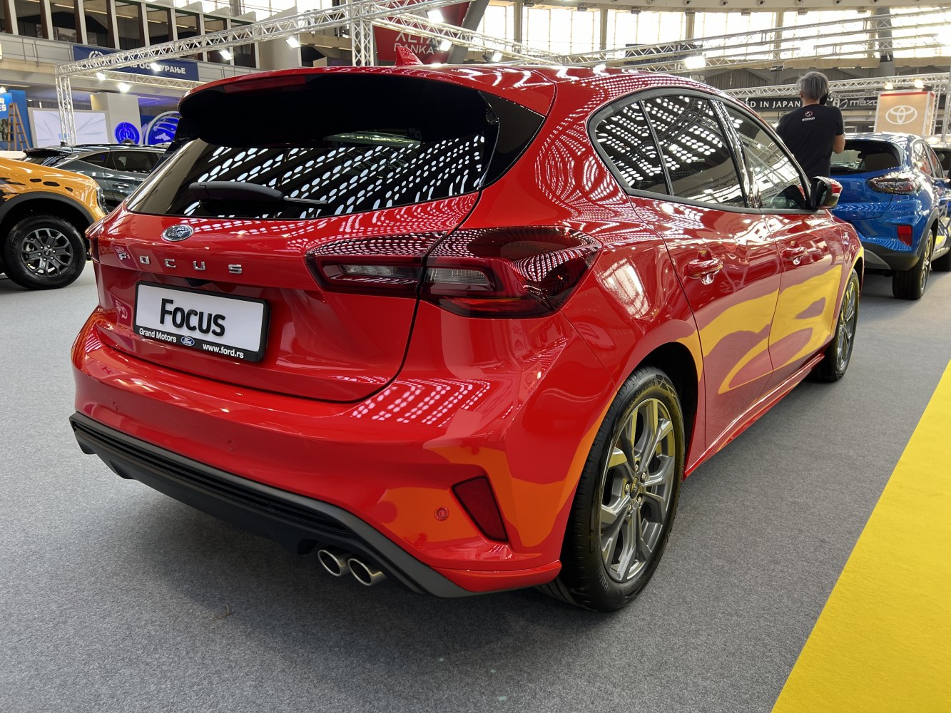 Red hatchback rear view with dual exhaust and sleek taillights