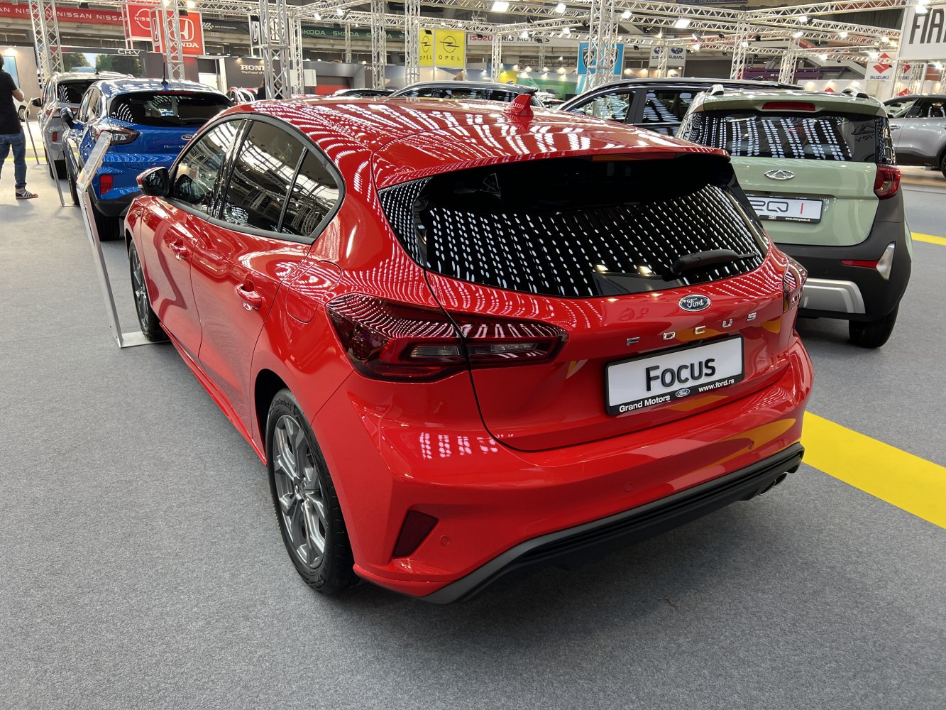 Rear view of a red compact hatchback with modern tail lights and sporty design