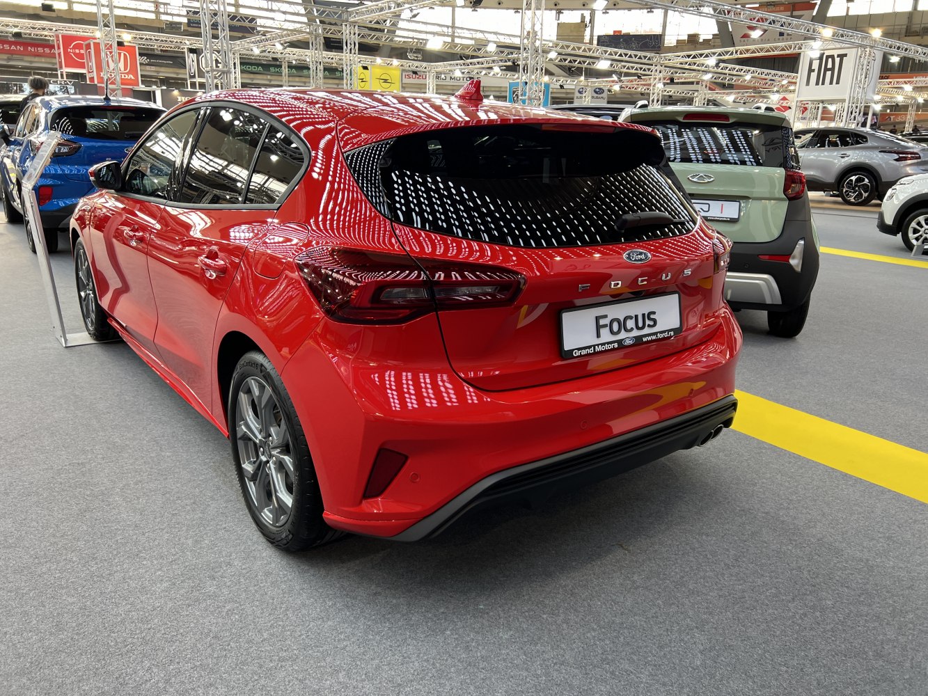 Rear view of a modern red hatchback with sleek taillights and sporty styling