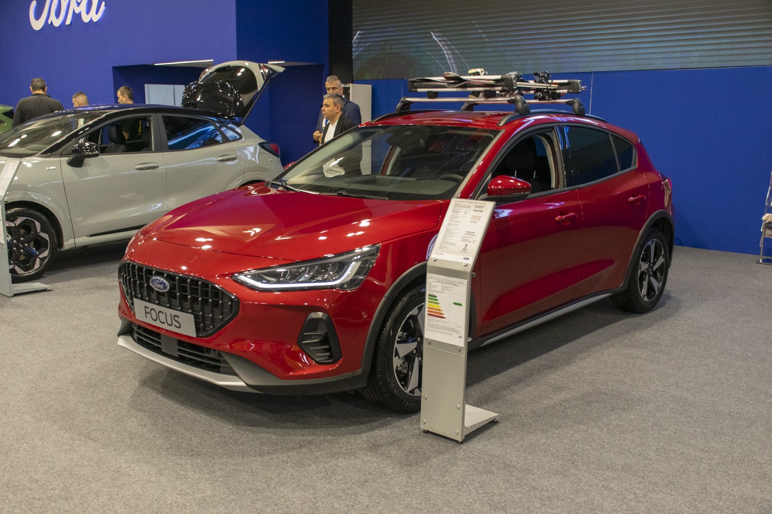 Red hatchback with roof rack and ski holders