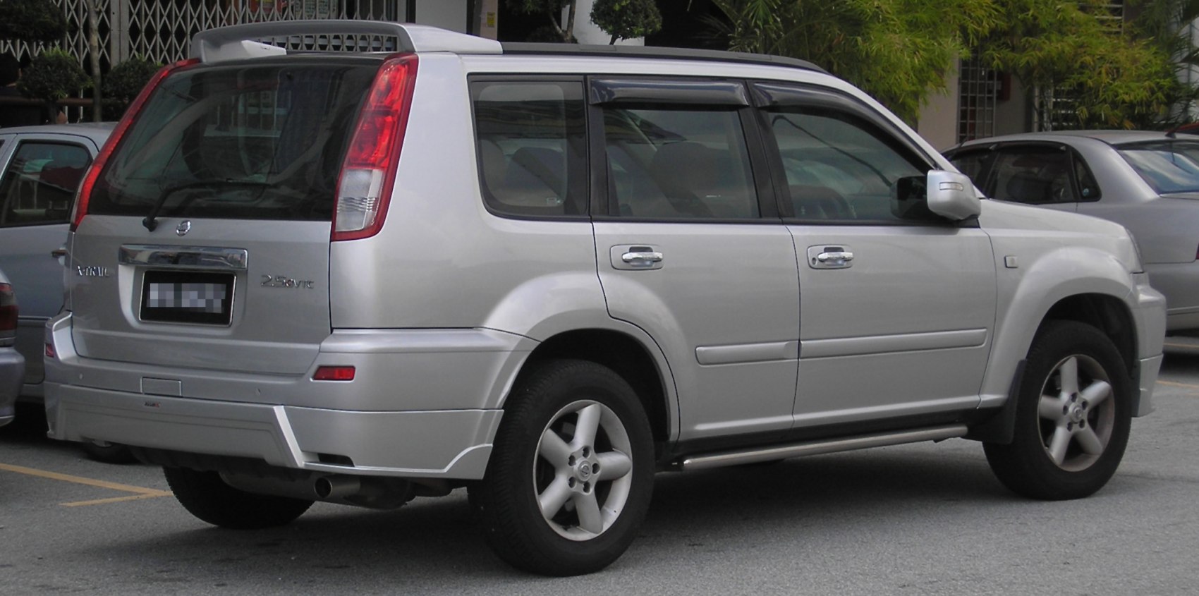 Rear and side view of a silver SUV with boxy profile and alloy wheels