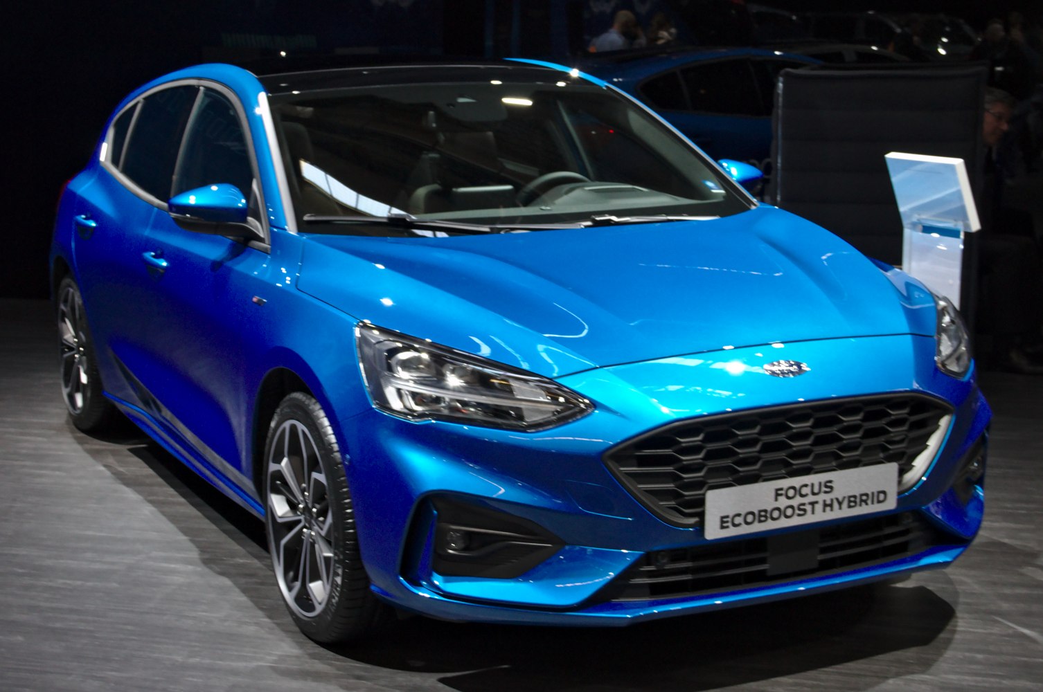 Front view of hatchback with modern headlights and honeycomb grille