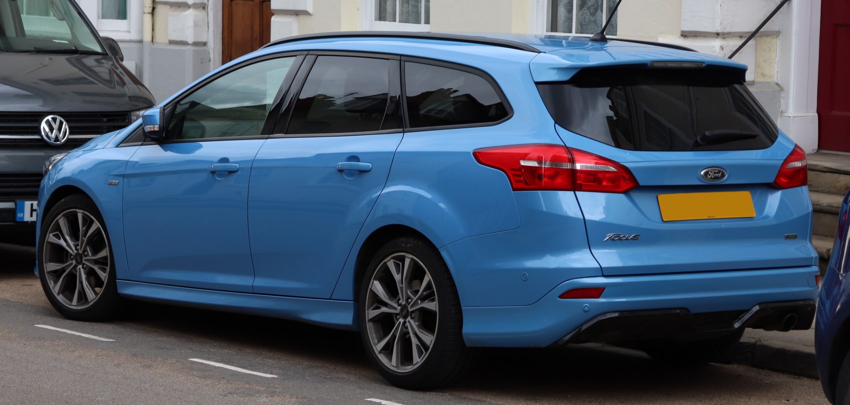 Rear and side profile view with tinted windows and alloy wheels