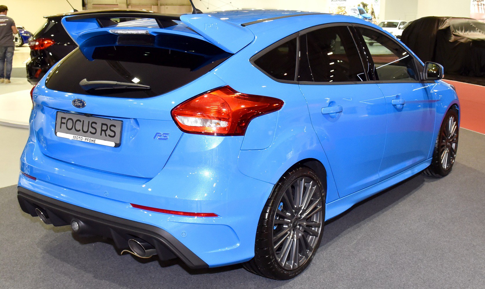 Blue hatchback with rear spoiler and twin exhausts