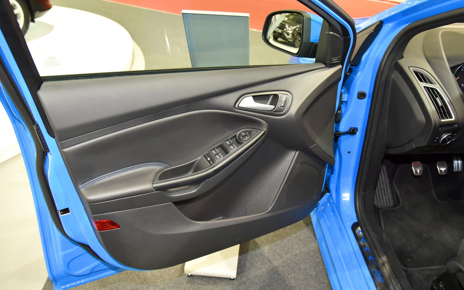 Driver-side interior door panel with control buttons and door handle