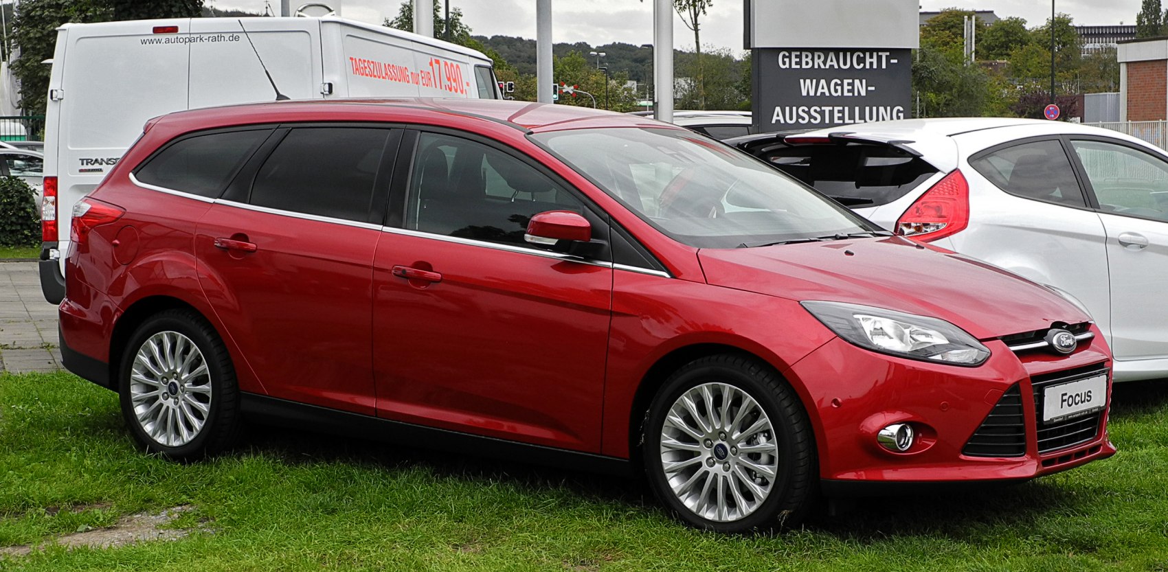 Red mid-size wagon with alloy wheels and fog lights