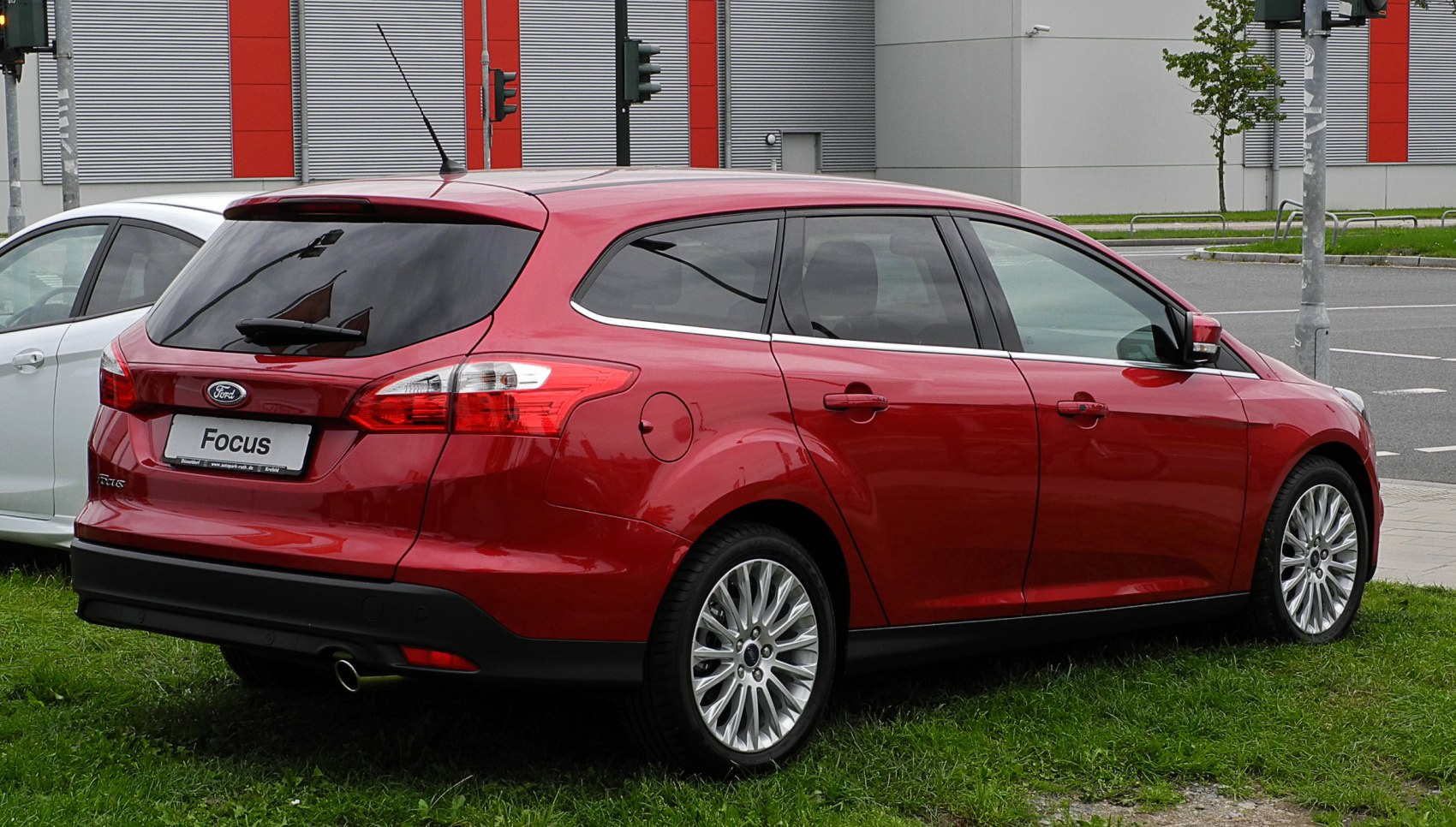 Rear side view of red wagon with tinted windows and alloy wheels