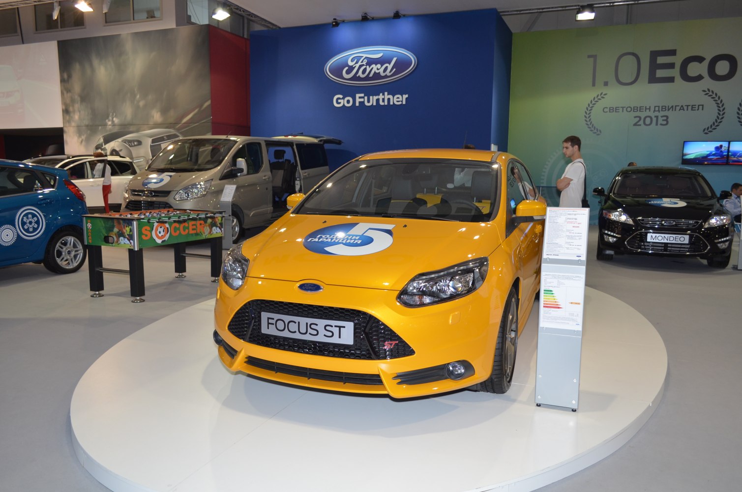 Bright yellow sporty hatchback with detailed front grille and headlights