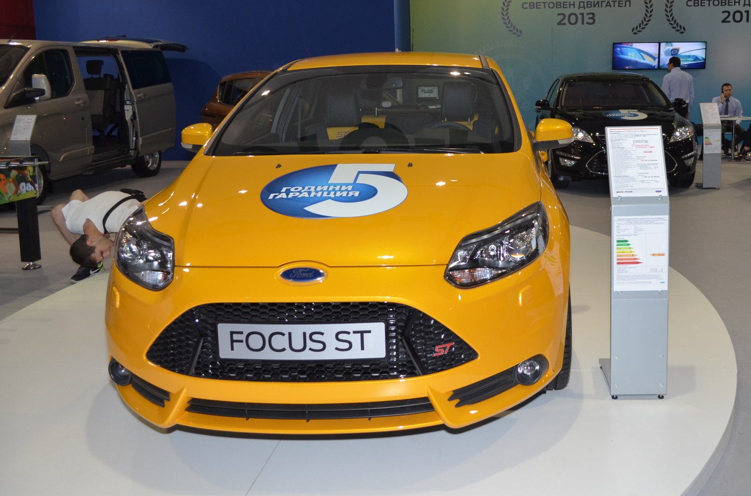 Yellow hatchback front view with sporty grille and headlights