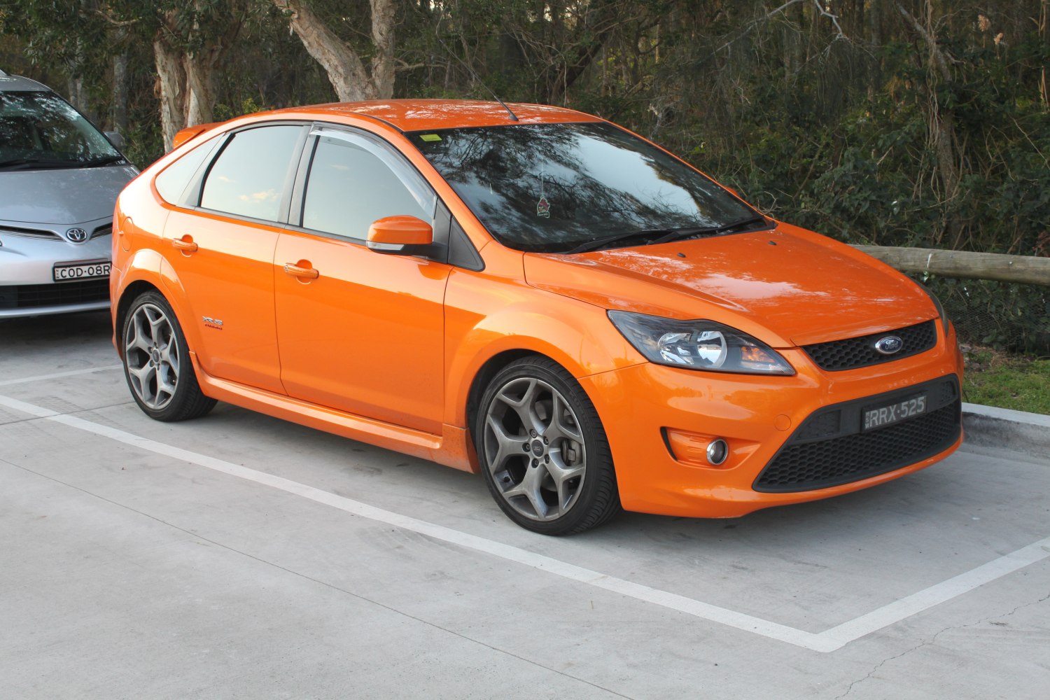 Orange hatchback with sporty alloy wheels and sleek front design
