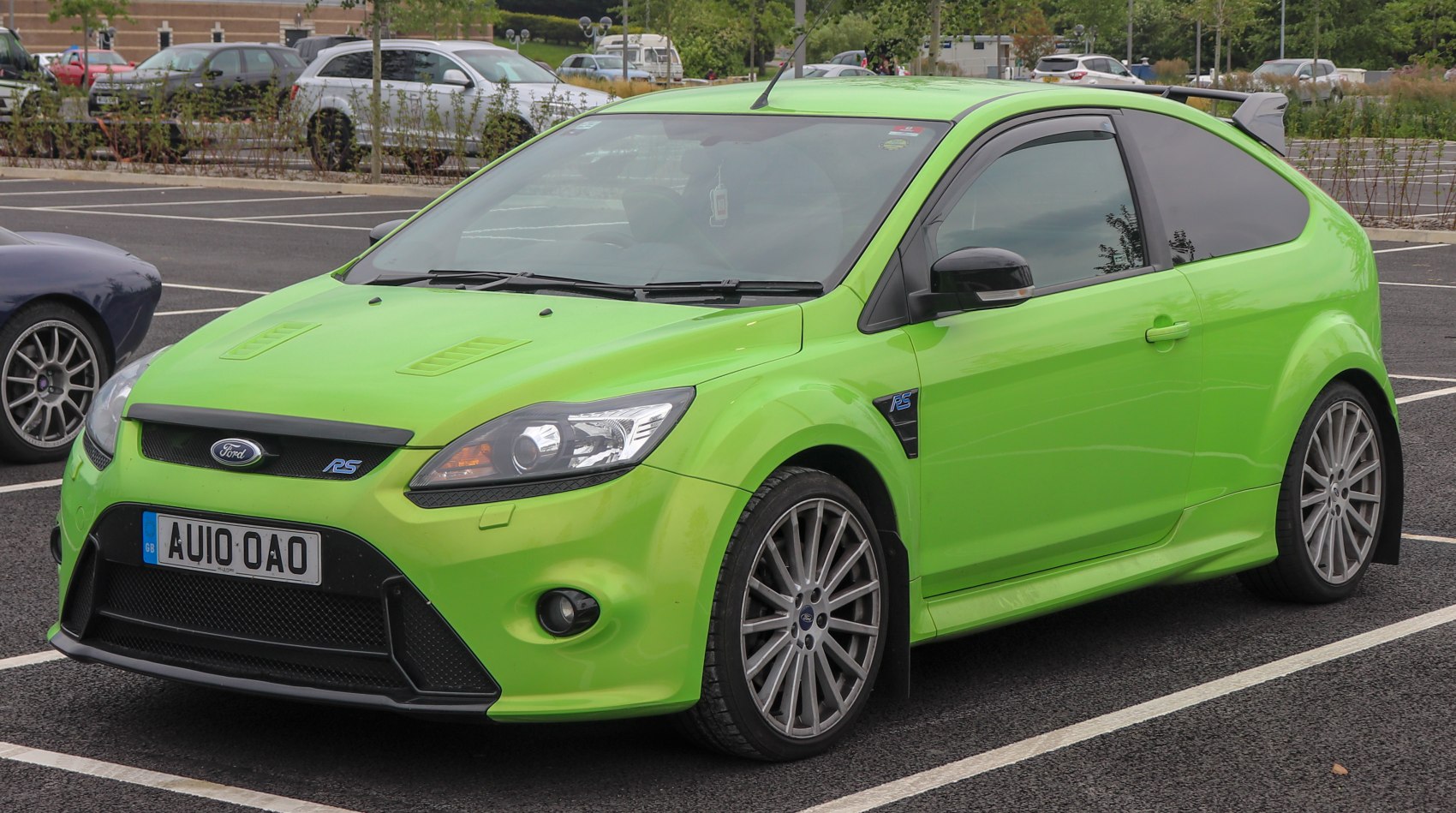 Sporty lime green hatchback with aggressive front and alloy wheels