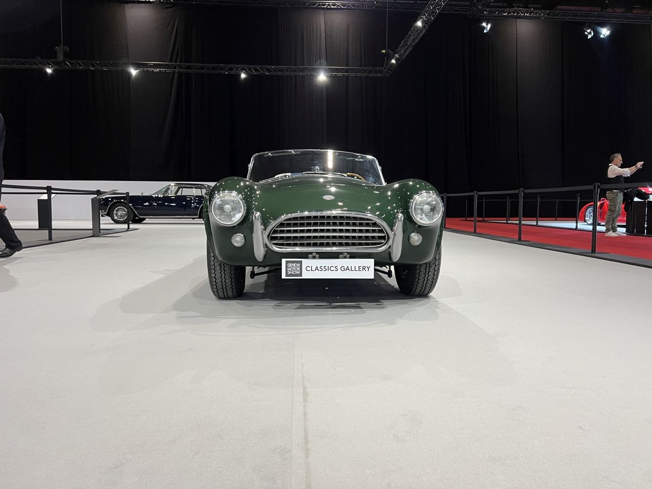 Front view of vintage roadster with round headlights and wide grille