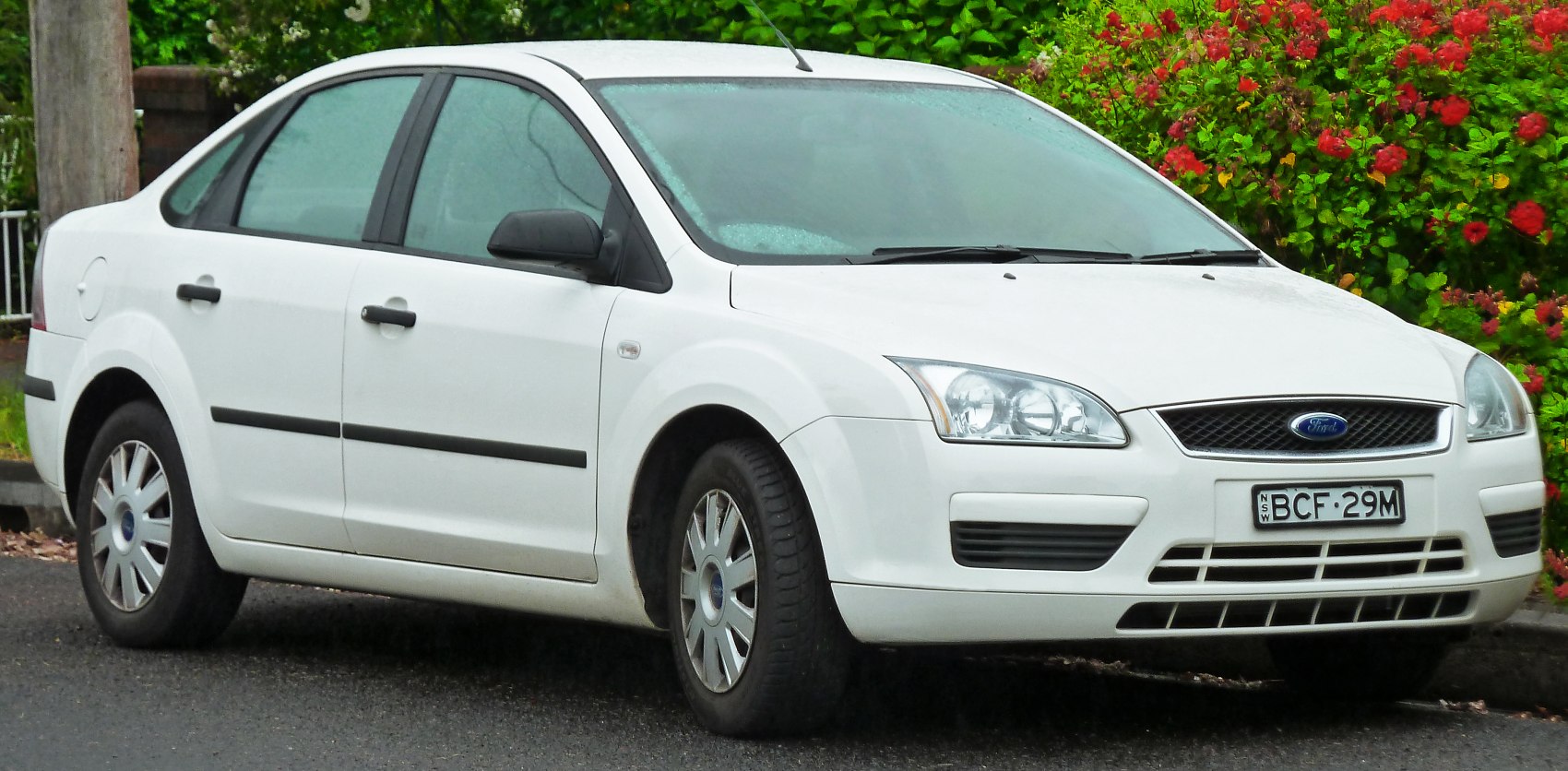 White four-door sedan front and side view with detailed headlights and grille