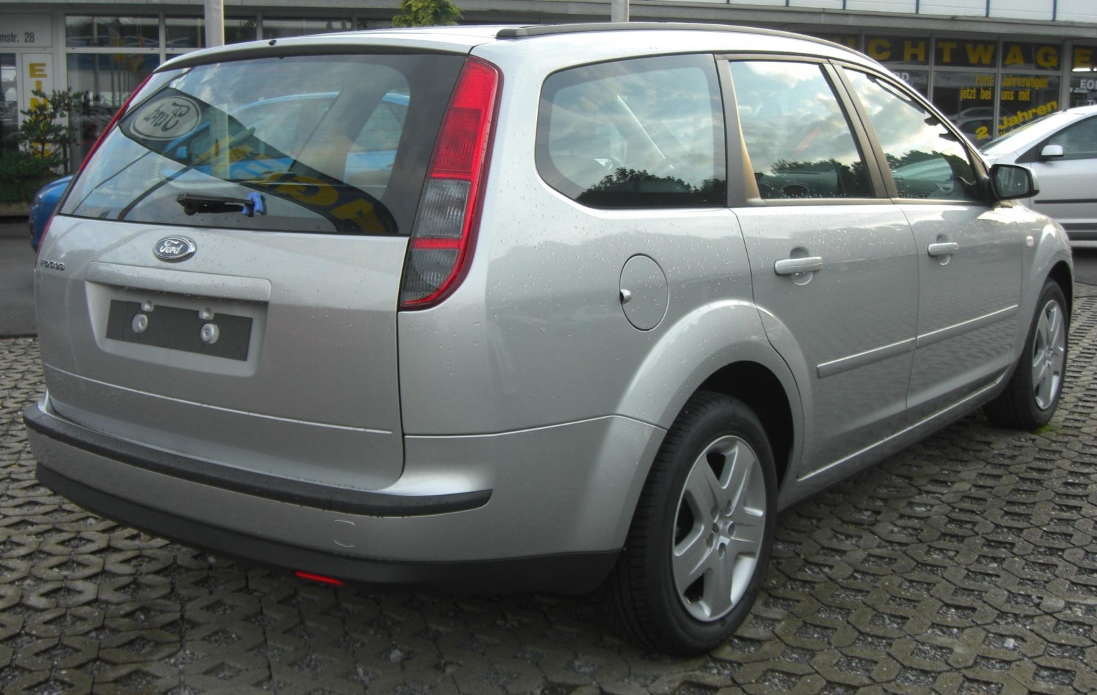 Silver station wagon rear side with vertical tail light and rear wiper