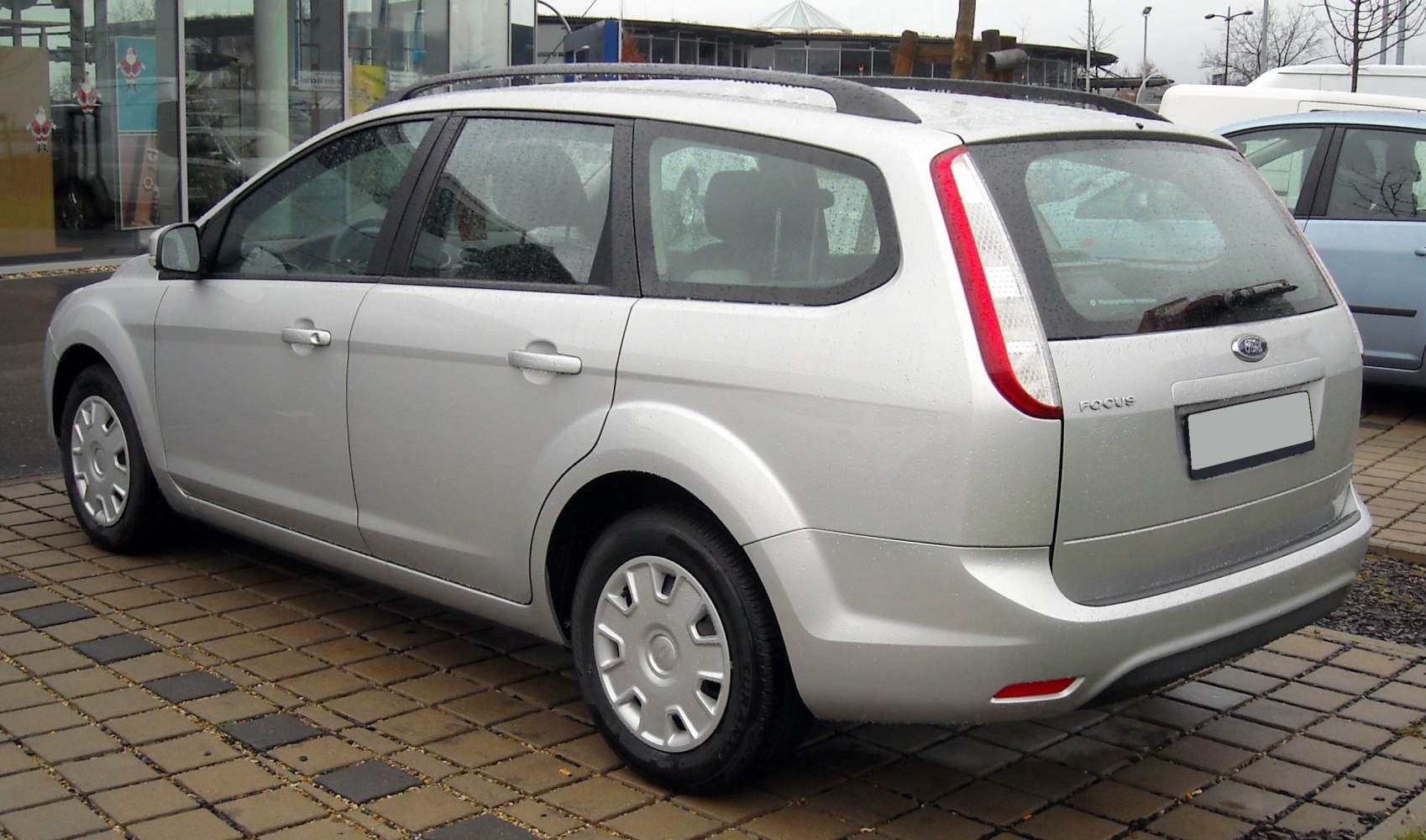 Silver station wagon rear side view with roof rails